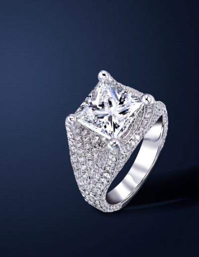 Handmade platinum ring. The center stone is a princess cut diamond. Ring is crusted with pure white round diamonds