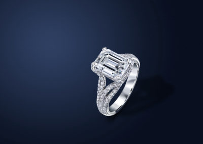 One of a kind handmade platinum ring. The center stone is an emerald cut diamond. Ring is paved with pure white diamonds.